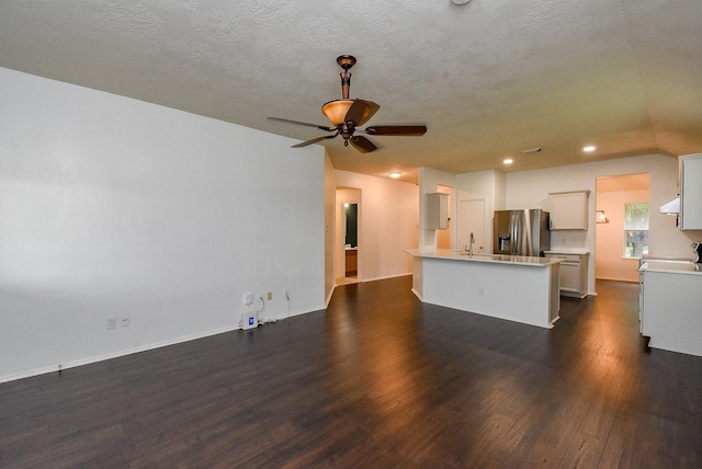 2715 Trinity Glen Ln, Houston, TX 77047 - unfurnished living room featuring dark wood-type flooring, ceiling fan, recessed lighting, and a textured ceiling