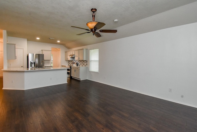 2715 Trinity Glen Ln, Houston, TX 77047 - unfurnished living room with dark wood finished floors, vaulted ceiling, ceiling fan, recessed lighting, and a textured ceiling