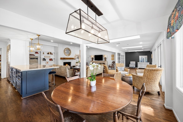 12215 Cobblestone Dr, Houston, TX 77024 - dining space with a fireplace, dark wood finished floors, and recessed lighting