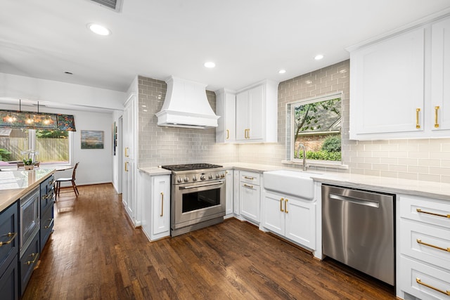 12215 Cobblestone Dr, Houston, TX 77024 - kitchen with appliances with stainless steel finishes, custom range hood, white cabinets, backsplash, and dark wood-style floors