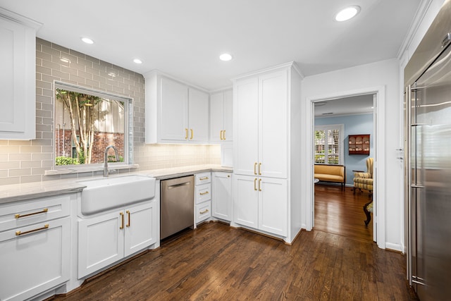 12215 Cobblestone Dr, Houston, TX 77024 - kitchen with appliances with stainless steel finishes, dark wood-style flooring, backsplash, white cabinetry, and light stone counters