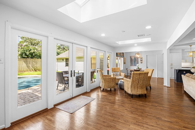 12215 Cobblestone Dr, Houston, TX 77024 - living area featuring a skylight, wood finished floors, french doors, and recessed lighting