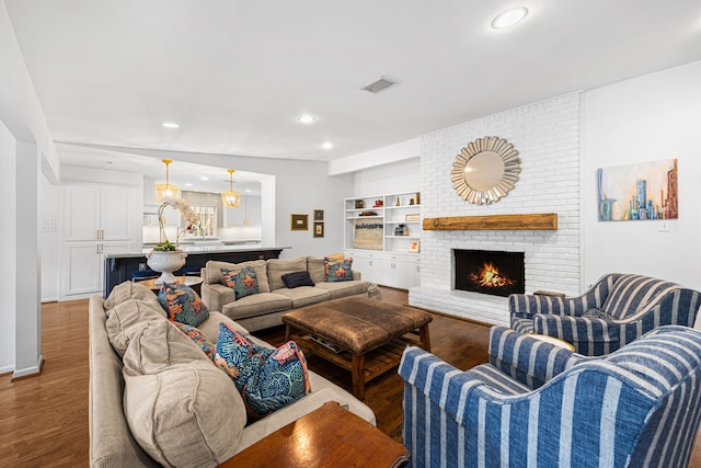12215 Cobblestone Dr, Houston, TX 77024 - living area with wood finished floors, a fireplace, and recessed lighting