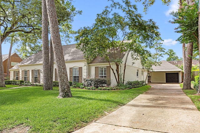 12215 Cobblestone Dr, Houston, TX 77024 - view of front of house with brick siding, a front lawn, driveway, roof with shingles, and an attached garage