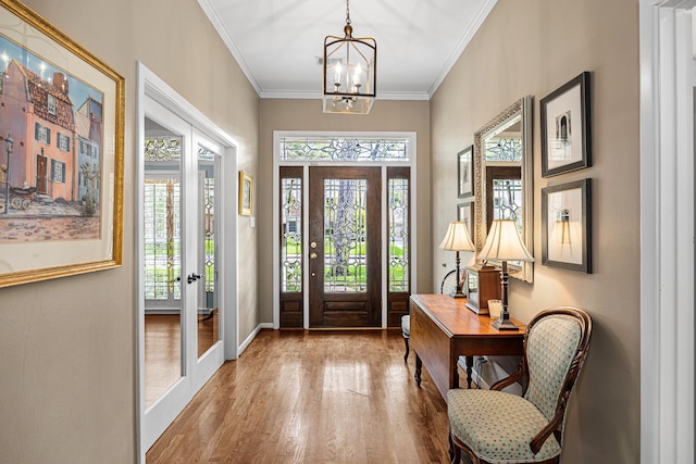 12215 Cobblestone Dr, Houston, TX 77024 - foyer entrance with wood finished floors, plenty of natural light, french doors, a chandelier, and crown molding