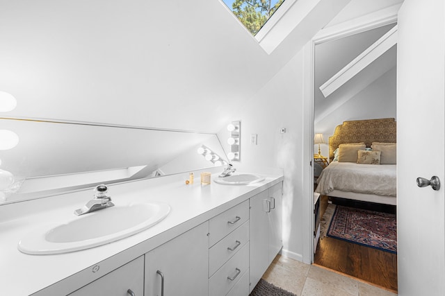 12215 Cobblestone Dr, Houston, TX 77024 - ensuite bathroom featuring lofted ceiling, double vanity, and a skylight
