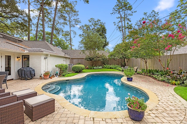 12215 Cobblestone Dr, Houston, TX 77024 - view of swimming pool with area for grilling, a fenced backyard, and a patio area