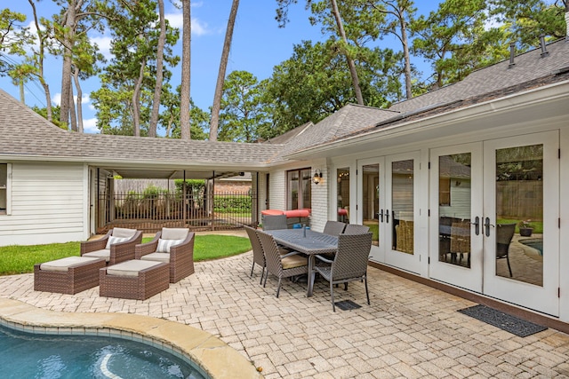 12215 Cobblestone Dr, Houston, TX 77024 - view of patio / terrace with french doors and an outdoor pool