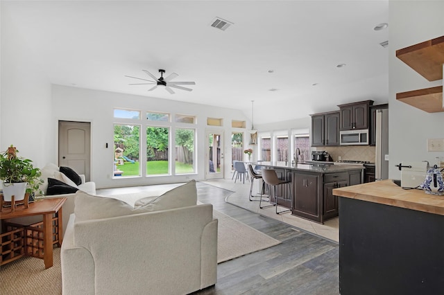13015 Barkley Bend Ln, Houston, TX 77044 - living area with a ceiling fan, light wood-style flooring, and lofted ceiling