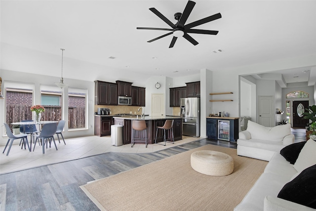 13015 Barkley Bend Ln, Houston, TX 77044 - living area with beverage cooler, light wood-style floors, and ceiling fan