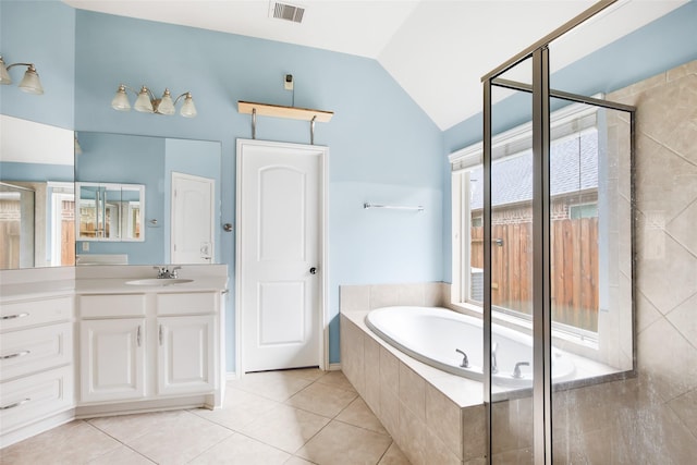 13015 Barkley Bend Ln, Houston, TX 77044 - bathroom with vaulted ceiling, a bath, vanity, tile patterned floors, and a tile shower