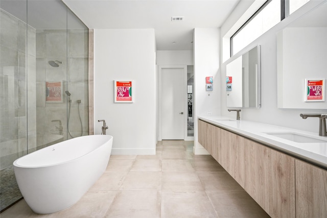 6508 Haskell St, Houston, TX 77007 - full bathroom with double vanity, a freestanding tub, a stall shower, and tile patterned flooring