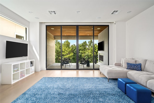 6508 Haskell St, Houston, TX 77007 - living area with expansive windows, wood finished floors, recessed lighting, and a fireplace