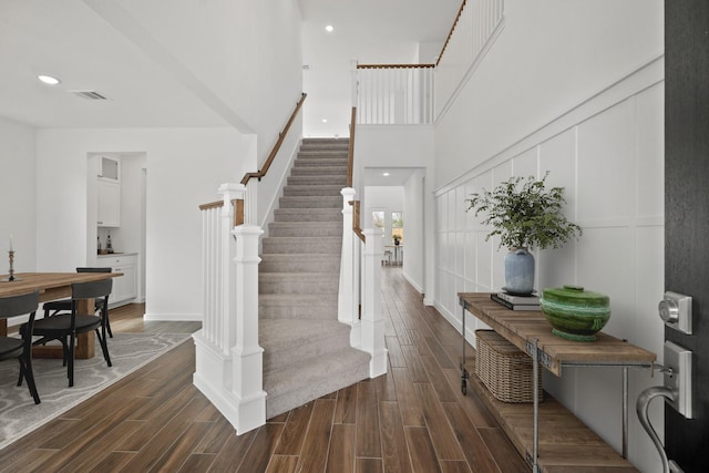 21218 Blue Bluff Dr, Cypress, TX 77433 - entrance foyer featuring stairs, dark wood-style floors, recessed lighting, and a towering ceiling