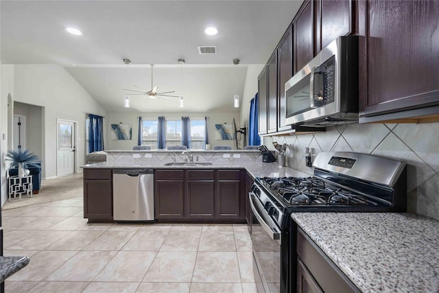 3218 Camelia Chase Ct, Spring, TX 77373 - kitchen with stainless steel appliances, decorative backsplash, dark brown cabinetry, ceiling fan, and a peninsula