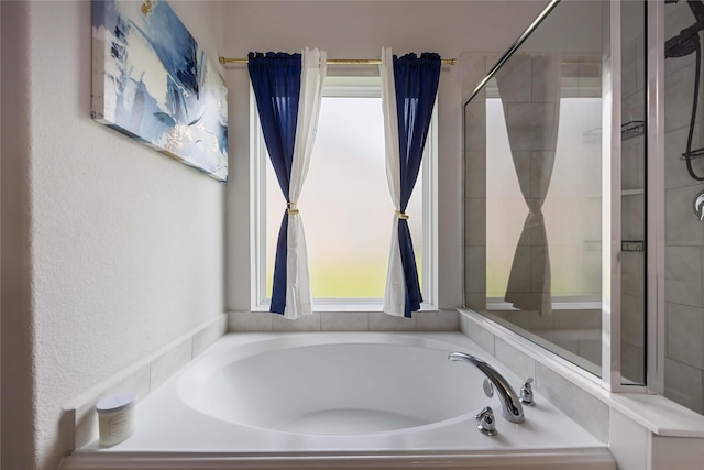3218 Camelia Chase Ct, Spring, TX 77373 - bathroom featuring a garden tub, healthy amount of natural light, and a textured wall