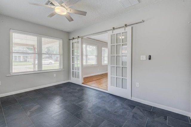 2007 Wakefield Dr, Houston, TX 77018 - empty room with a barn door and ceiling fan