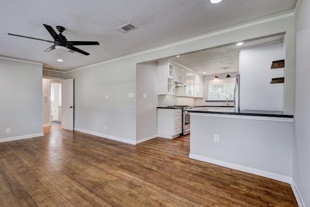 2007 Wakefield Dr, Houston, TX 77018 - unfurnished living room featuring crown molding, ceiling fan, recessed lighting, and dark wood finished floors