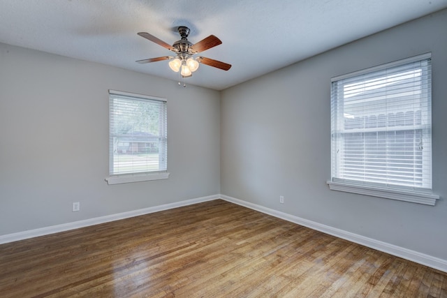 2007 Wakefield Dr, Houston, TX 77018 - empty room featuring plenty of natural light, wood finished floors, and a ceiling fan