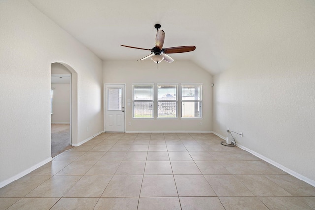 19842 Haven Cliff Ln, Cypress, TX 77433 - empty room with ceiling fan, arched walkways, light tile patterned floors, and lofted ceiling