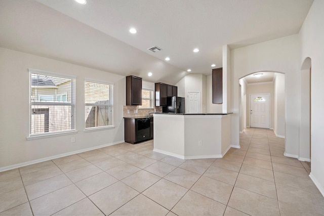 19842 Haven Cliff Ln, Cypress, TX 77433 - kitchen featuring black appliances, arched walkways, light tile patterned flooring, tasteful backsplash, and lofted ceiling