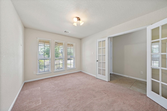 19842 Haven Cliff Ln, Cypress, TX 77433 - spare room featuring french doors, carpet flooring, and a textured ceiling