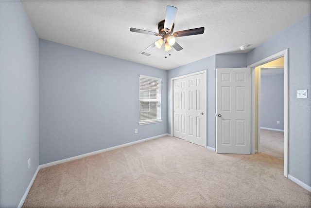 19842 Haven Cliff Ln, Cypress, TX 77433 - unfurnished bedroom with carpet floors, a closet, a textured ceiling, and ceiling fan