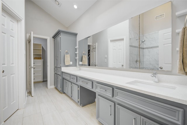 6510 Preston Trail Dr, Houston, TX 77069 - full bathroom with a tile shower, vaulted ceiling, double vanity, a spacious closet, and recessed lighting