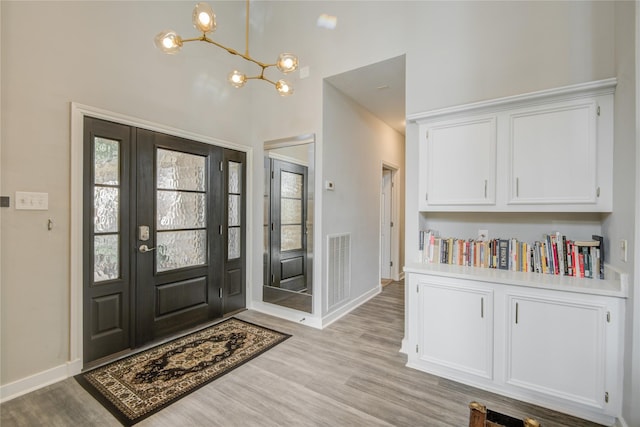 6510 Preston Trail Dr, Houston, TX 77069 - entryway featuring light wood-type flooring, a chandelier, and a towering ceiling