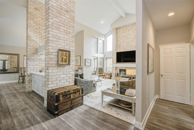 6510 Preston Trail Dr, Houston, TX 77069 - living area with high vaulted ceiling, wood finished floors, a brick fireplace, and beamed ceiling