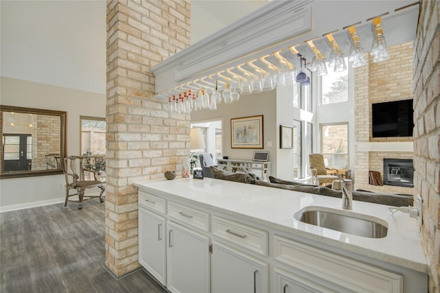 6510 Preston Trail Dr, Houston, TX 77069 - kitchen with dark wood-style flooring, open floor plan, plenty of natural light, white cabinetry, and a high ceiling