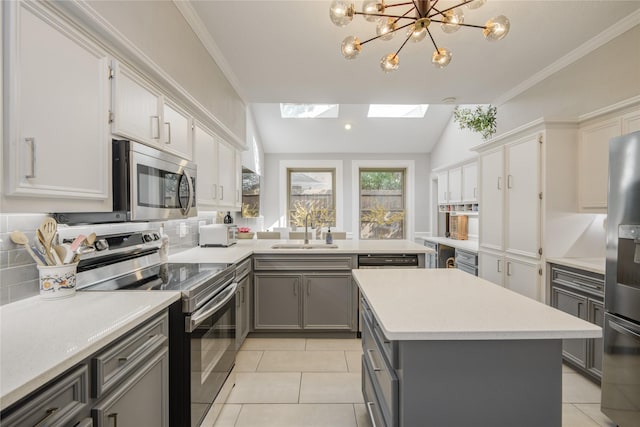 6510 Preston Trail Dr, Houston, TX 77069 - kitchen with appliances with stainless steel finishes, gray cabinets, light countertops, a skylight, and light tile patterned floors