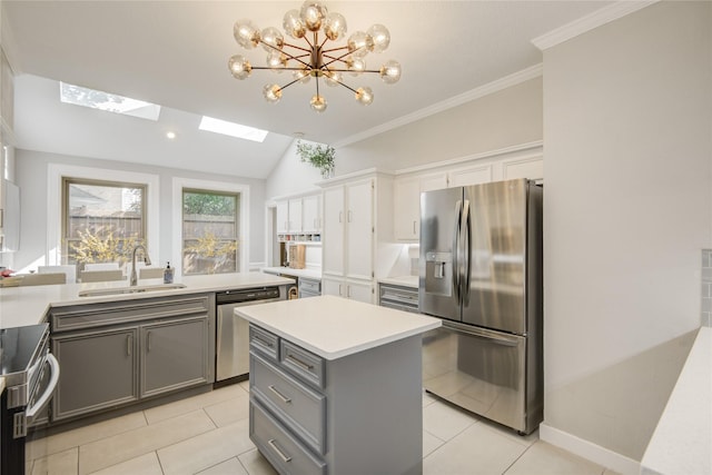 6510 Preston Trail Dr, Houston, TX 77069 - kitchen featuring stainless steel appliances, gray cabinets, a chandelier, light countertops, and a skylight