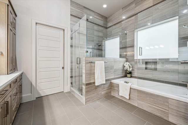 4615 Verone St, Bellaire, TX 77401 - full bath with tile patterned floors, a bath, vanity, a stall shower, and recessed lighting