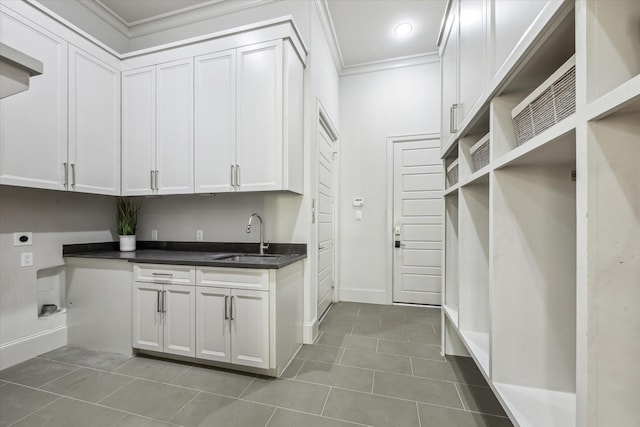 4615 Verone St, Bellaire, TX 77401 - laundry room with electric dryer hookup, tile patterned flooring, ornamental molding, cabinet space, and recessed lighting