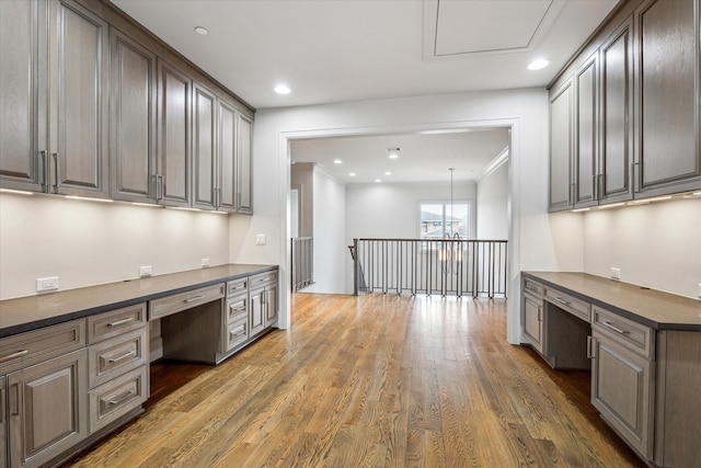 4615 Verone St, Bellaire, TX 77401 - unfurnished office featuring built in desk, wood finished floors, recessed lighting, and ornamental molding