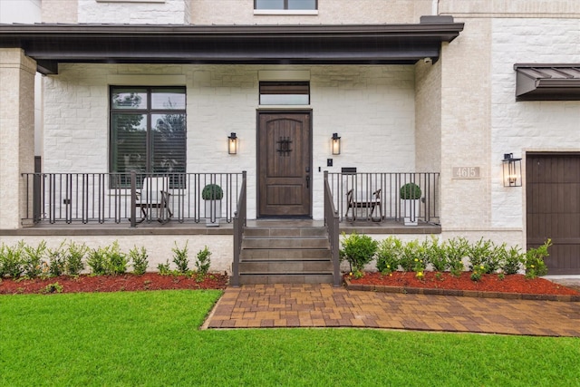 4615 Verone St, Bellaire, TX 77401 - view of exterior entry featuring a porch, a yard, and stone siding