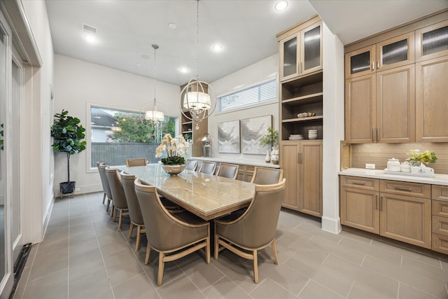 4615 Verone St, Bellaire, TX 77401 - dining area with light tile patterned floors, recessed lighting, and a chandelier