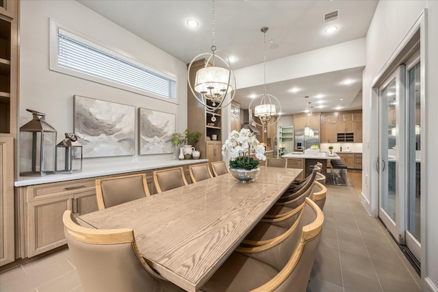 4615 Verone St, Bellaire, TX 77401 - tiled dining room with a chandelier and recessed lighting