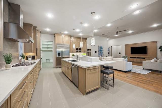 4615 Verone St, Bellaire, TX 77401 - kitchen featuring appliances with stainless steel finishes, wall chimney range hood, a kitchen breakfast bar, backsplash, and open floor plan