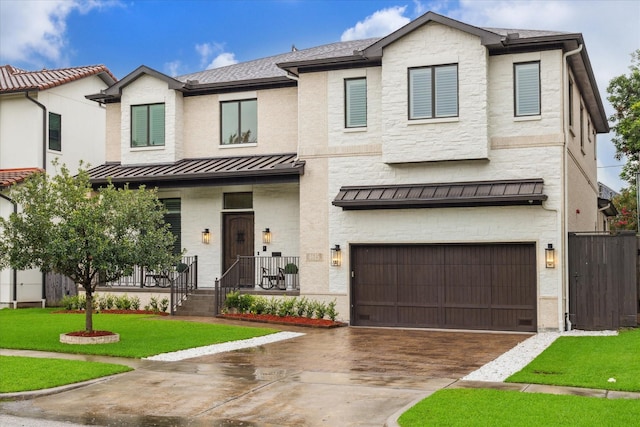 4615 Verone St, Bellaire, TX 77401 - view of front facade featuring a standing seam roof, an attached garage, driveway, covered porch, and stone siding