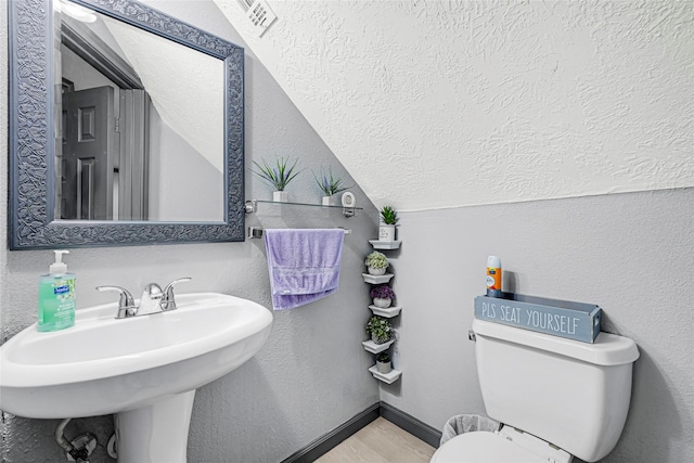 17103 Scuttle Way, Crosby, TX 77532 - bathroom with lofted ceiling, a textured wall, and a textured ceiling