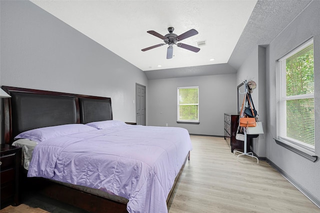 17103 Scuttle Way, Crosby, TX 77532 - bedroom with light wood-style floors, a ceiling fan, a textured ceiling, and lofted ceiling