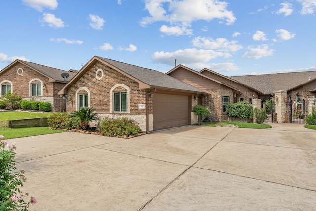 111 Bessie Price Owen Dr, Montgomery, TX 77356 - view of front of home featuring brick siding, concrete driveway, an attached garage, roof with shingles, and a gate