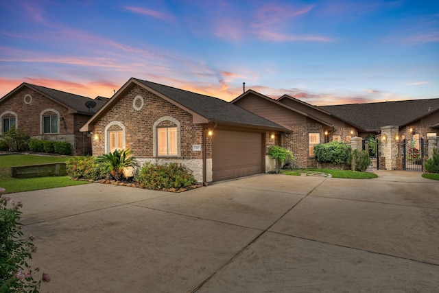 111 Bessie Price Owen Dr, Montgomery, TX 77356 - view of front facade with brick siding, driveway, an attached garage, a shingled roof, and stone siding