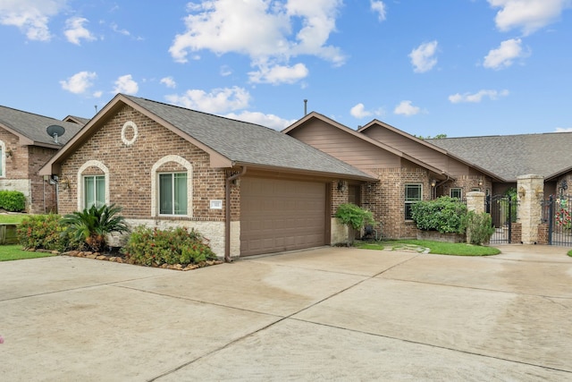 111 Bessie Price Owen Dr, Montgomery, TX 77356 - view of front of home with brick siding, roof with shingles, driveway, and an attached garage