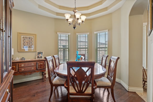 111 Bessie Price Owen Dr, Montgomery, TX 77356 - dining room with a chandelier, arched walkways, dark wood finished floors, and a raised ceiling