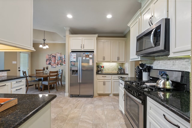 111 Bessie Price Owen Dr, Montgomery, TX 77356 - kitchen featuring stainless steel appliances, tasteful backsplash, a chandelier, crown molding, and dark stone counters
