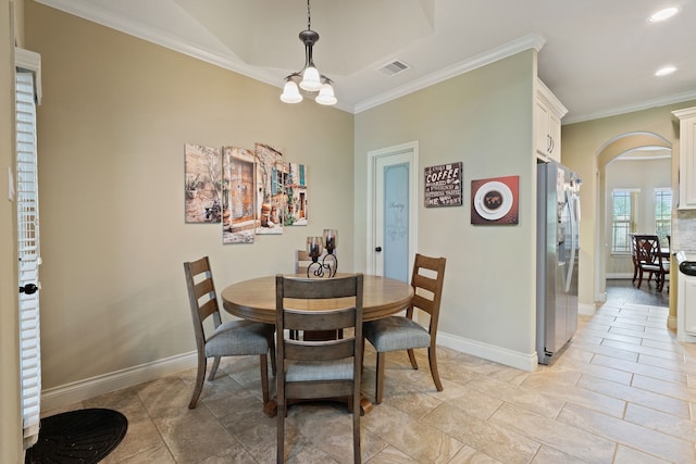 111 Bessie Price Owen Dr, Montgomery, TX 77356 - dining space with arched walkways, crown molding, recessed lighting, and a chandelier