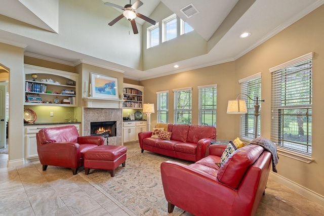 111 Bessie Price Owen Dr, Montgomery, TX 77356 - living room featuring a ceiling fan, a warm lit fireplace, built in features, recessed lighting, and arched walkways